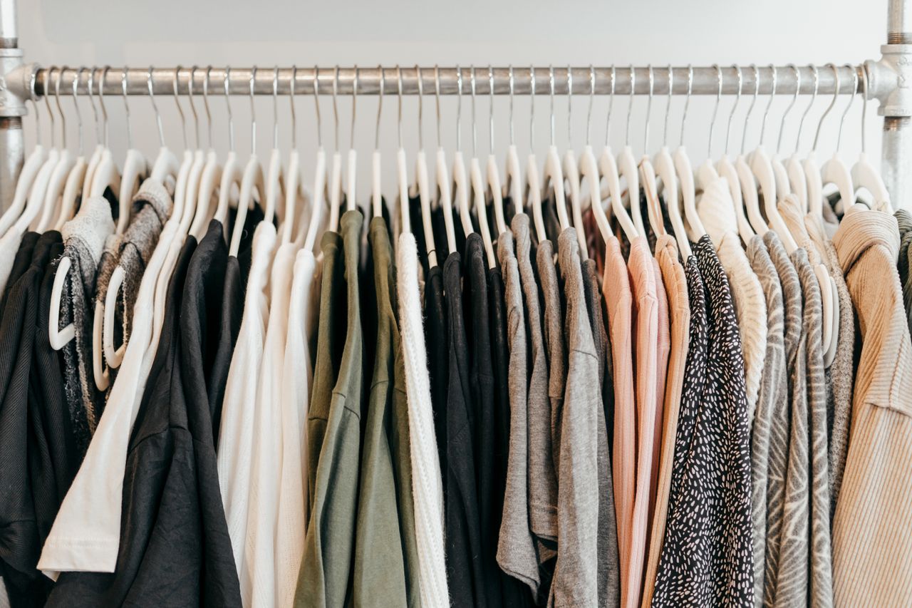 Neatly arranged clothing on hangers showcasing a variety of fabrics and styles.