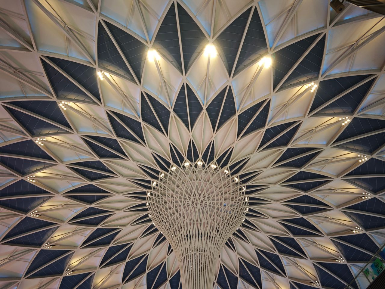 A stunning view of a geometric dome ceiling showcasing intricate architectural design and lighting.